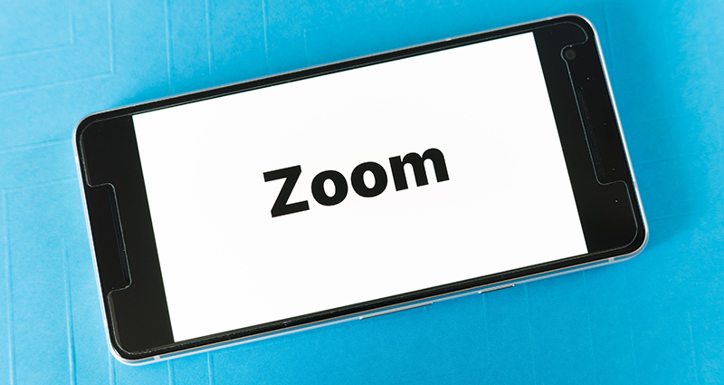 An iPhone with the word Zoom on the screen